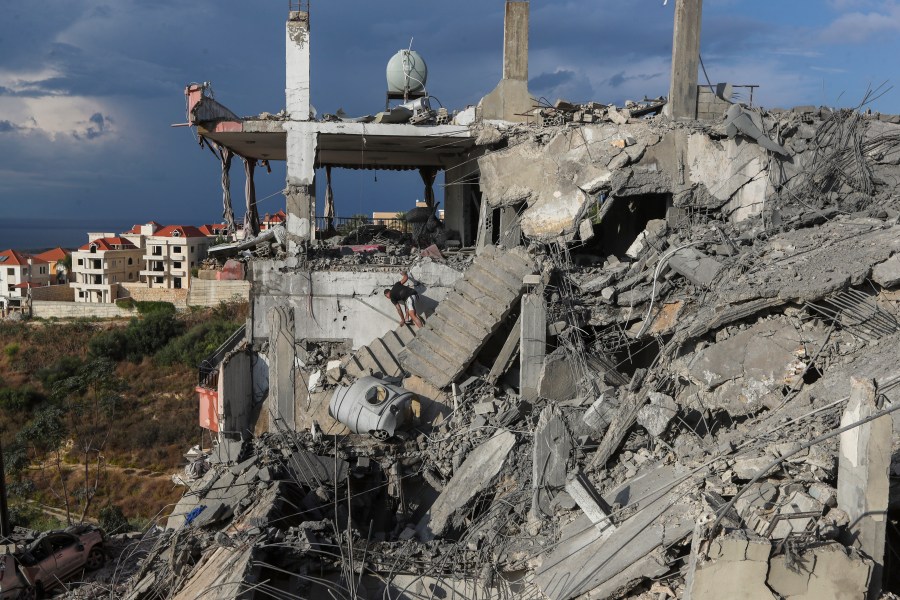 A man inspects a destroyed building hit in an Israeli airstrike, in Ghaziyeh town, south Lebanon, Sunday, Nov. 3, 2024. (AP Photo/Mohammed Zaatari)