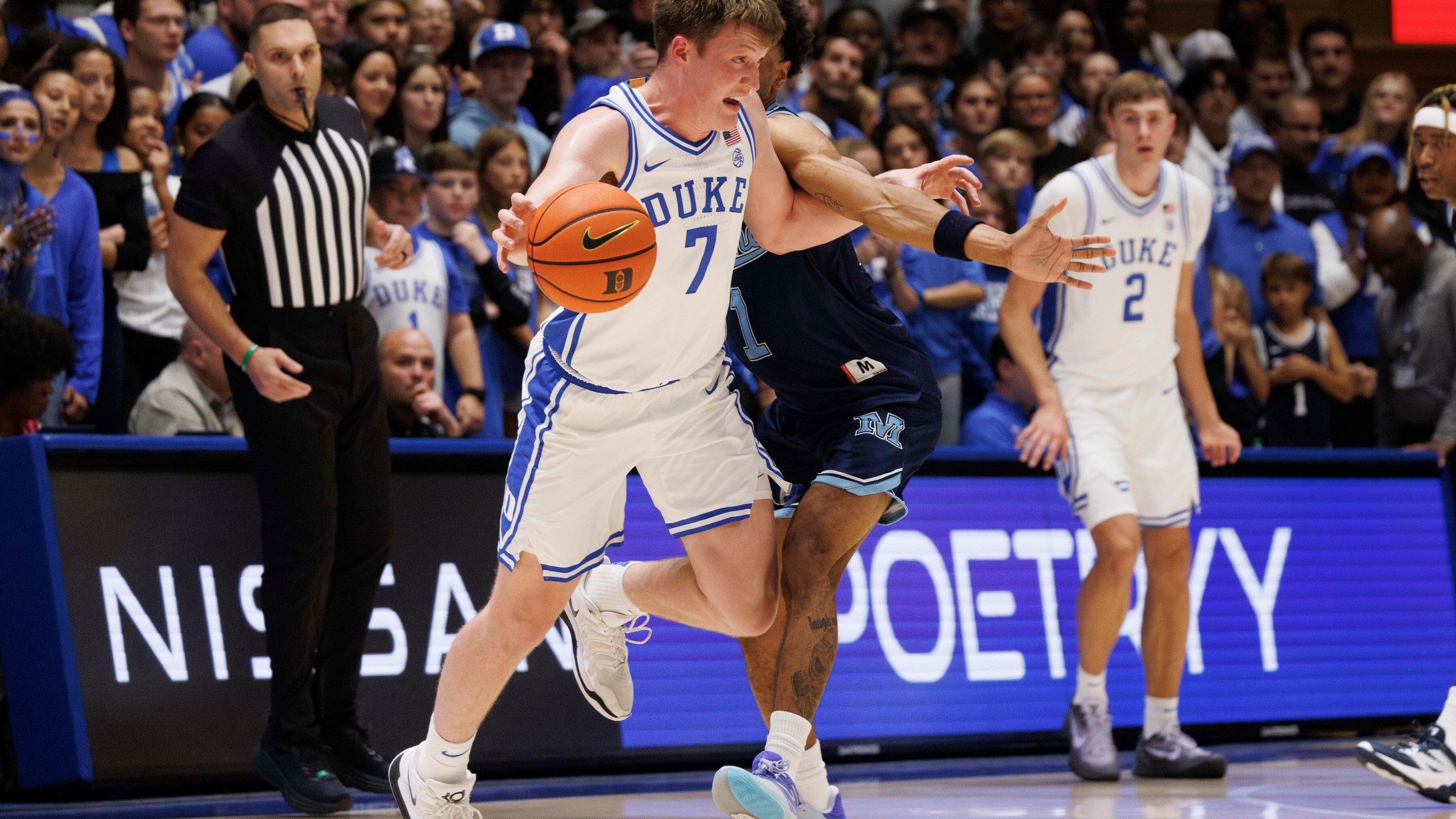 Duke's Kon Knueppel (7) handles the ball as Maine's Kellen Tynes (1) defends during the first half of an NCAA college basketball game in Durham, N.C., Monday, Nov. 4, 2024. (AP Photo/Ben McKeown)