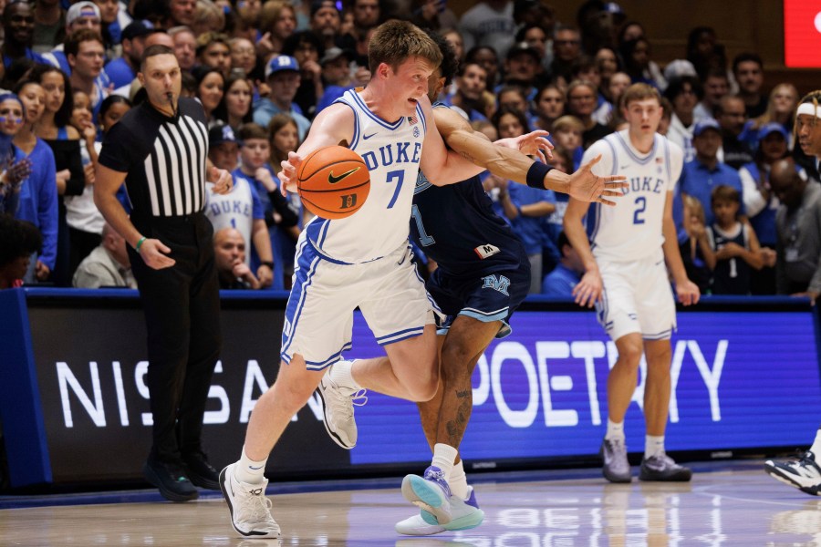 Duke's Kon Knueppel (7) handles the ball as Maine's Kellen Tynes (1) defends during the first half of an NCAA college basketball game in Durham, N.C., Monday, Nov. 4, 2024. (AP Photo/Ben McKeown)