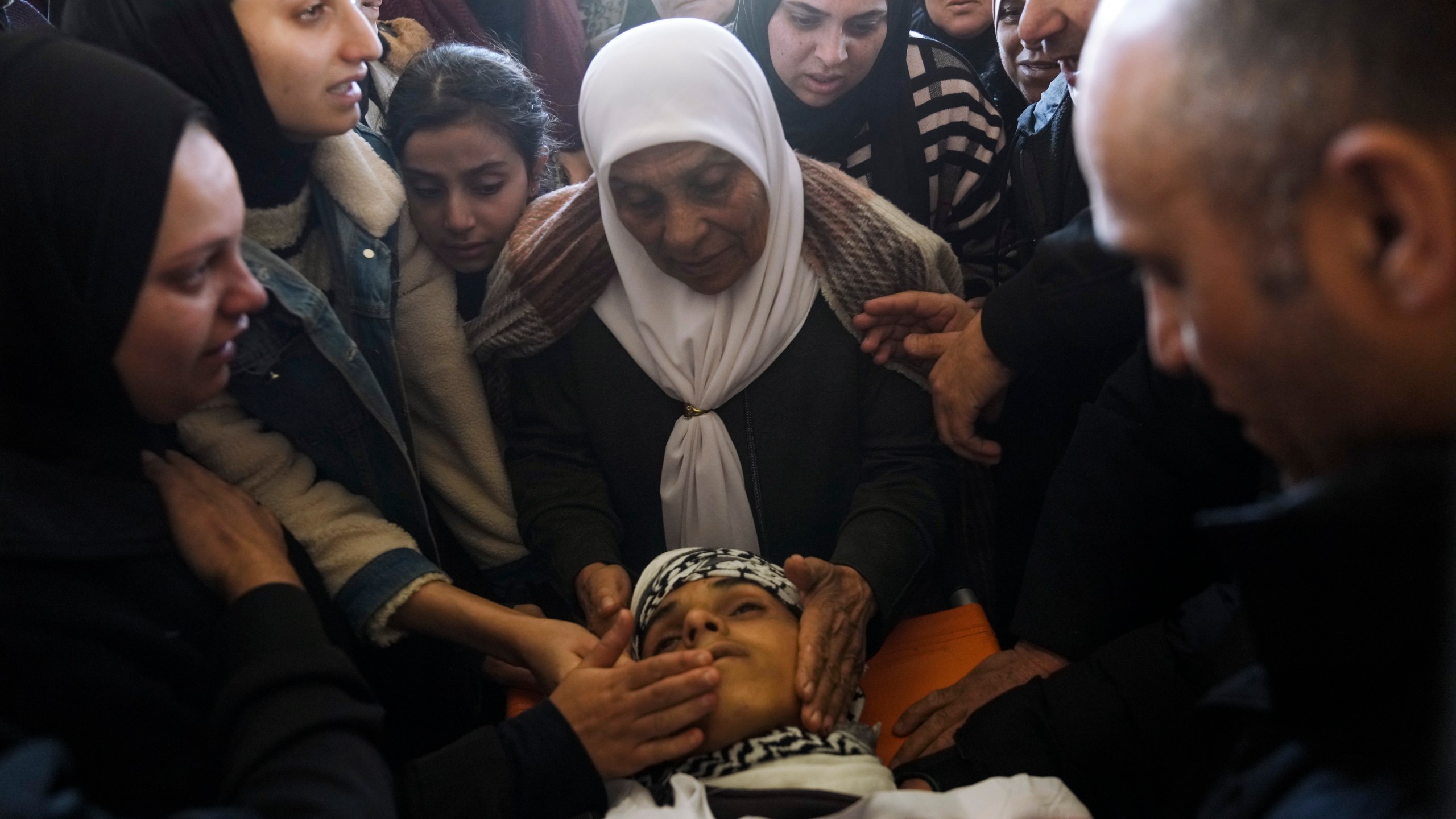 Palestinians mourn over the body of Naji al-Baba,16, who the Palestinian Health Ministry said was killed by Israeli forces in the town of Halhul, West Bank, during his funeral on Monday, Nov. 4, 2024. (AP Photo/Mahmoud Illean)