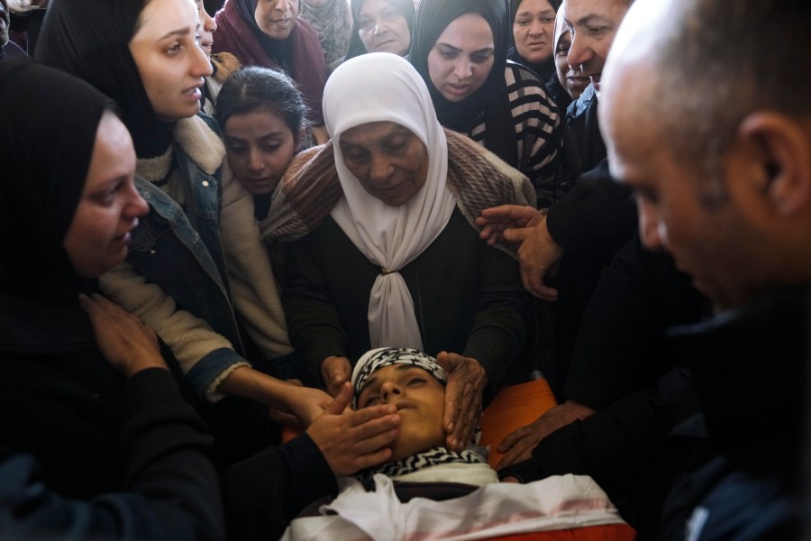 Palestinians mourn over the body of Naji al-Baba,16, who the Palestinian Health Ministry said was killed by Israeli forces in the town of Halhul, West Bank, during his funeral on Monday, Nov. 4, 2024. (AP Photo/Mahmoud Illean)