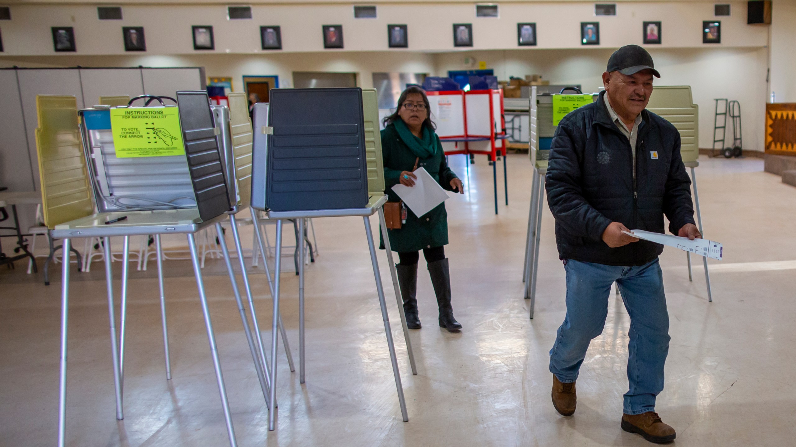 Voters look for the tabulation machine after marking their ballots at a polling station on the Navajo Nation in Fort Defiance, Ariz., on Election Day, Tuesday, Nov. 5, 2024. (AP Photo/Andres Leighton)