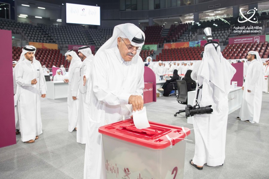 In this image released by the state-run Qatar News Agency, a Qatari votes in a snap poll to decide whether to end its limited voting for legislative seats in Doha, Qatar, Tuesday, Nov. 5, 2024. (Qatar News Agency via AP)