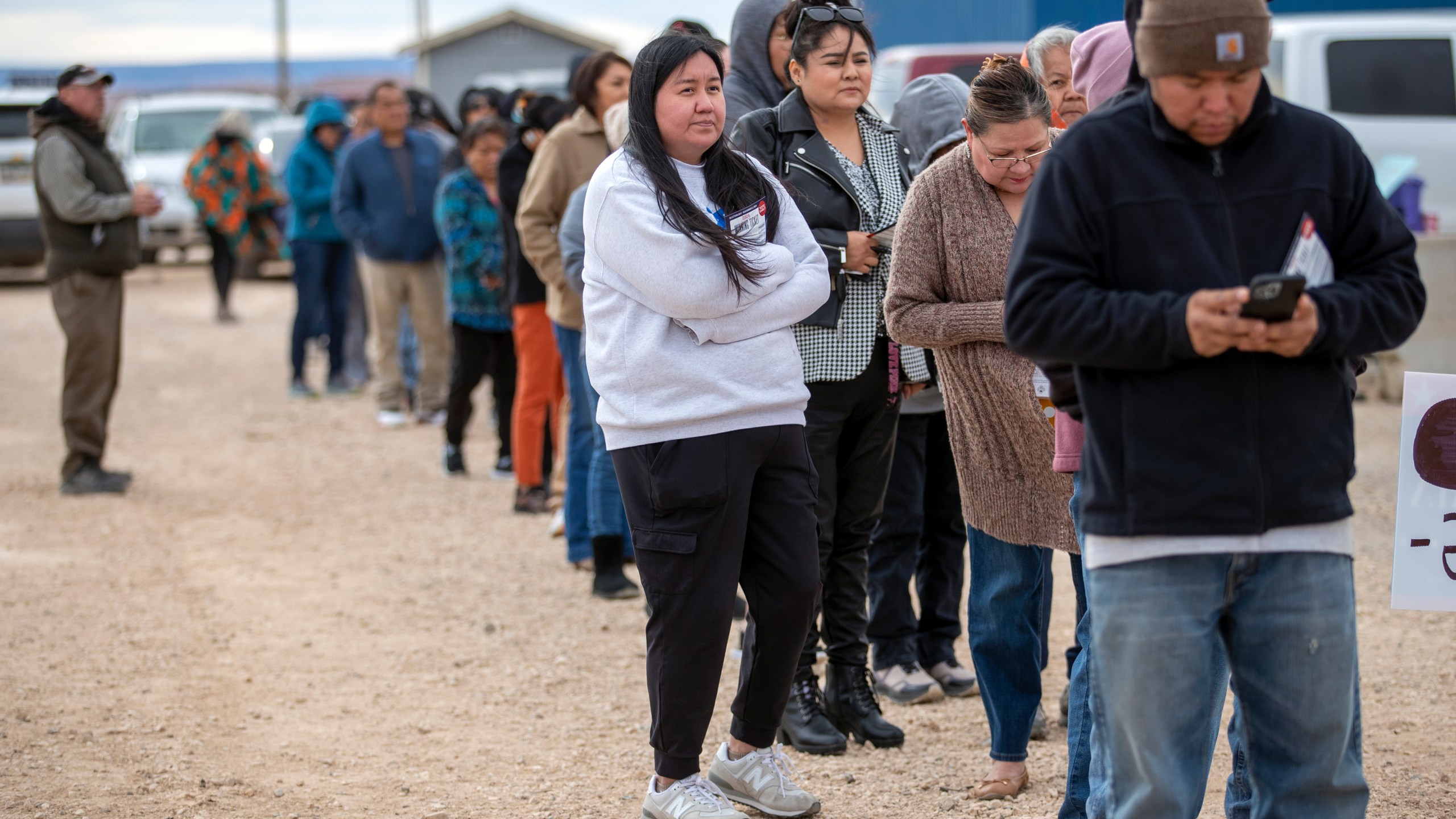 Voters wait in line to cast their ballots outside a polling station on the Navajo Nation in Chinle, Ariz., on Election Day, Tuesday, Nov. 5, 2024. (AP Photo/Andres Leighton)