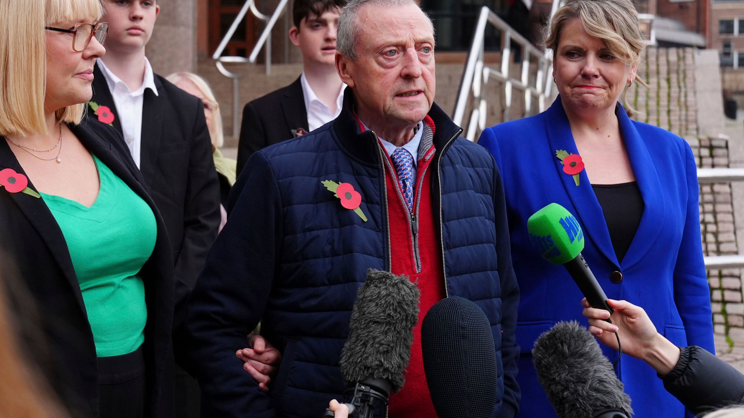 Patrick O'Hara, center, talks to the media outside the Newcastle Crown Court, in Newcastle, England, Wednesday, Nov. 6, 2024 where Dr. Thomas Kwan, was sentenced to 31 years and five months after he attempted to murder Mr O'Hara, who was his mother's partner, with a poisoned fake Covid jab whilst disguised as a nurse. (Owen Humphreys/PA via AP)