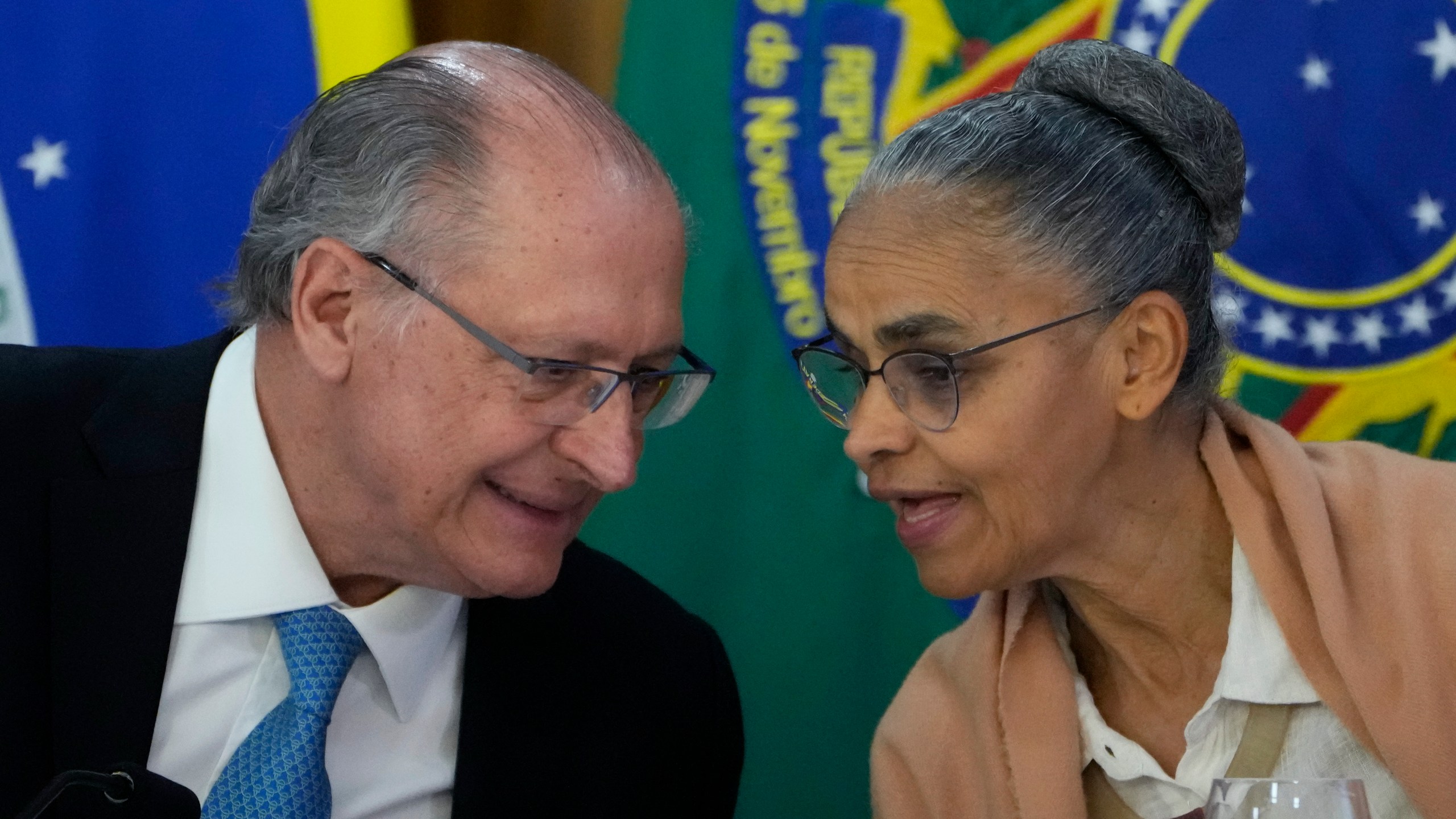 Brazil's Environment Minister Marina Silva, right, chats with Vice President Geraldo Alckmin during the announcement of a plan to combat fires and deforestation in the Amazon and the Brazilian Cerrado, at Planalto presidential palace in Brasilia, Brazil, Wednesday, Nov. 6, 2024. (AP Photo/Eraldo Peres)