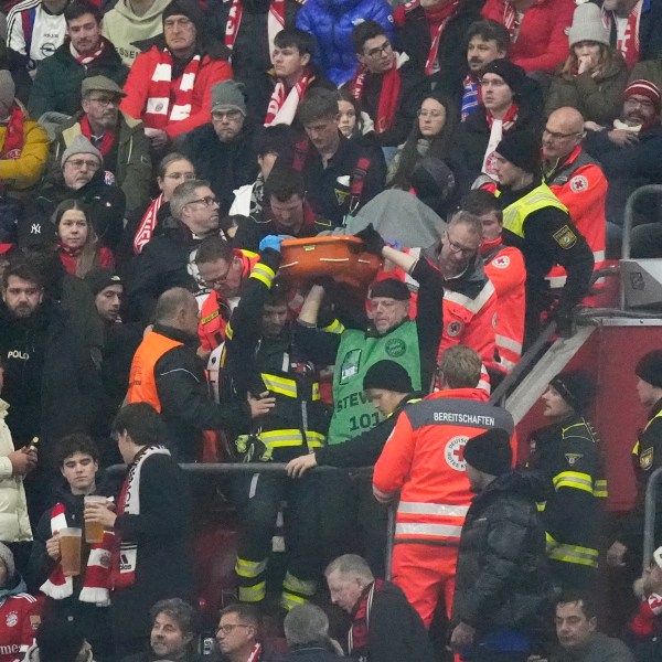 Police officers and paramedics carry a stretcher down the stands during a medical emergency during the Champions League opening phase soccer match between Bayern Munich and SL Benfica, in Munich, Germany, Wednesday, Nov. 6, 2024. (AP Photo/Matthias Schrader)