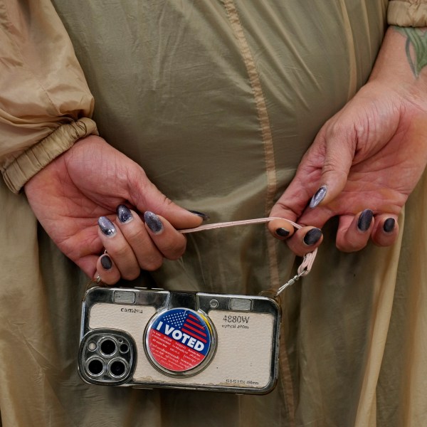 Marsha Molinari of West Hollywood, Calif., holds a cell phone at a polling place at the Connie Norman Transgender Empowerment Center on Election Day, Tuesday, Nov. 5, 2024, in West Hollywood, Calif. (AP Photo/Chris Pizzello)