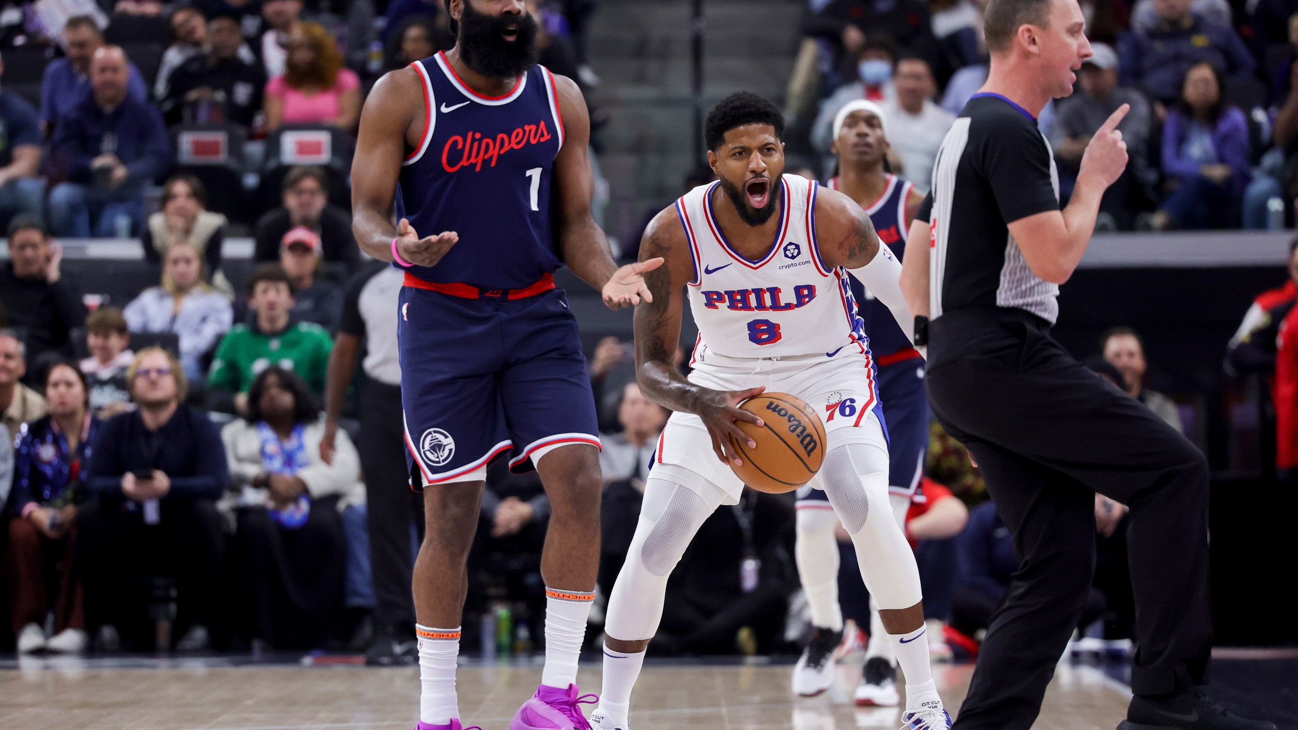 Philadelphia 76ers forward Paul George (8) and Los Angeles Clippers guard James Harden (1) react after a call during the first half of an NBA basketball game, Wednesday, Nov. 6, 2024, in Inglewood, Calif. (AP Photo/Ryan Sun)