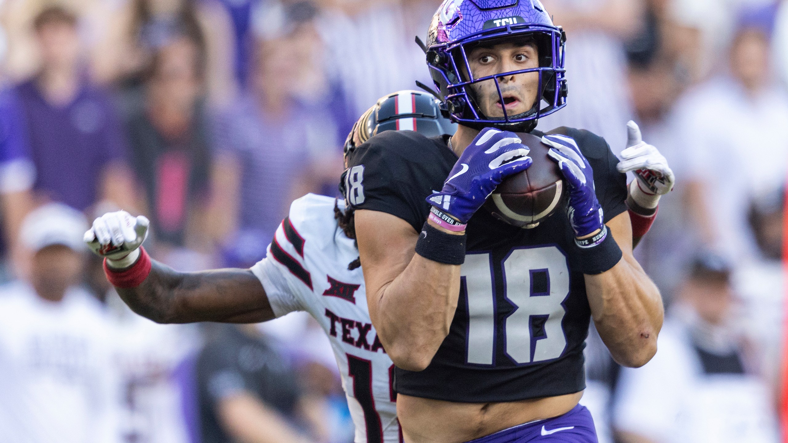 TCU wide receiver Jack Bech (18) catches a long pass from quarterback Josh Hoover (10) while guarded by Texas Tech defensive back Macho Stevenson (12) in the second half of an NCAA college football game in Fort Worth, Texas, Saturday, Oct. 26, 2024. (Chris Torres/Star-Telegram via AP)