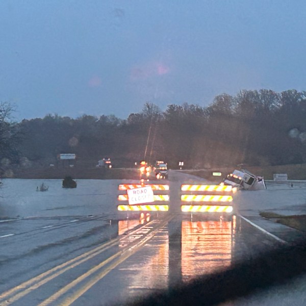 In a photo released by the Missouri State Highway Patrol, a tractor trailer sits submerged in flood water on US 63 just north of Cabool, Mo., Tuesday, Nov. 5, 2024. (Missouri State Highway Patrol via AP)