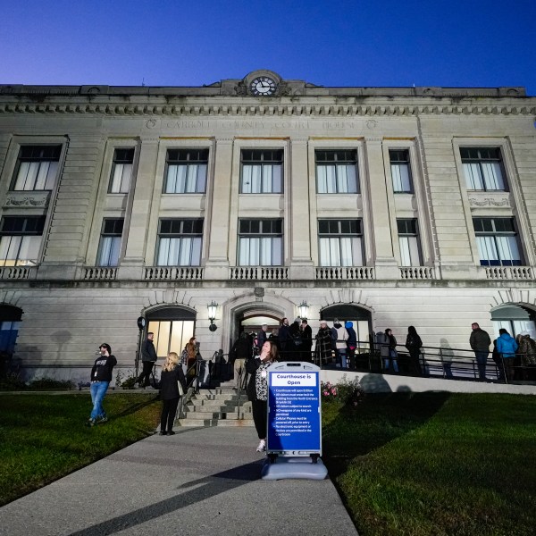 Spectators line up to enter the Carroll County Courthouse for the trail of Richard Allen, accused of the slayings of two teenage girls in 2017, is set to begin in Delphi, Ind., Friday, Oct. 18, 2024. (AP Photo/Michael Conroy)