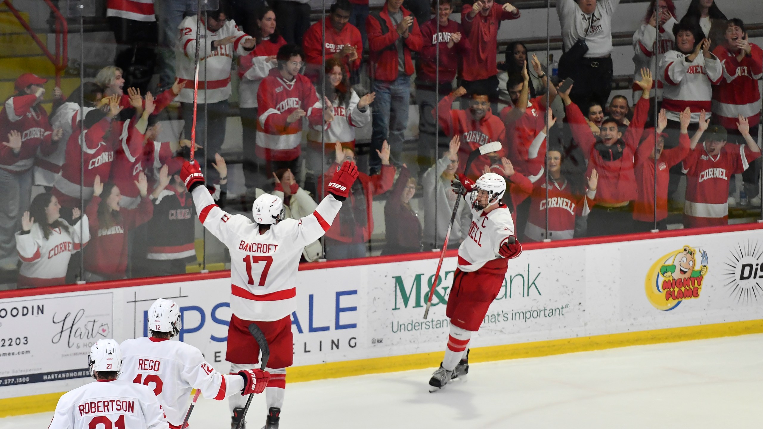 FILE - Cornell forward Kyle Penney, right, celebrates with forward Dalton Bancroft (17) after scoring during the third period of an NCAA hockey game against North Dakota on Nov. 2, 2024 in Ithaca, N.Y. (AP Photo/Adrian Kraus, file)