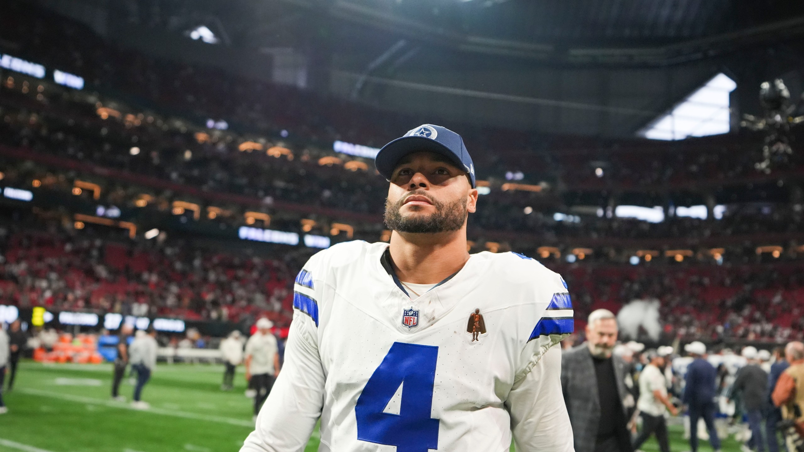 Dallas Cowboys quarterback Dak Prescott (4) walks off the field after an NFL football game against the Atlanta Falcons, Sunday, Nov. 3, 2024, in Atlanta. The Falcons won 27-21. (AP Photo/ Brynn Anderson)