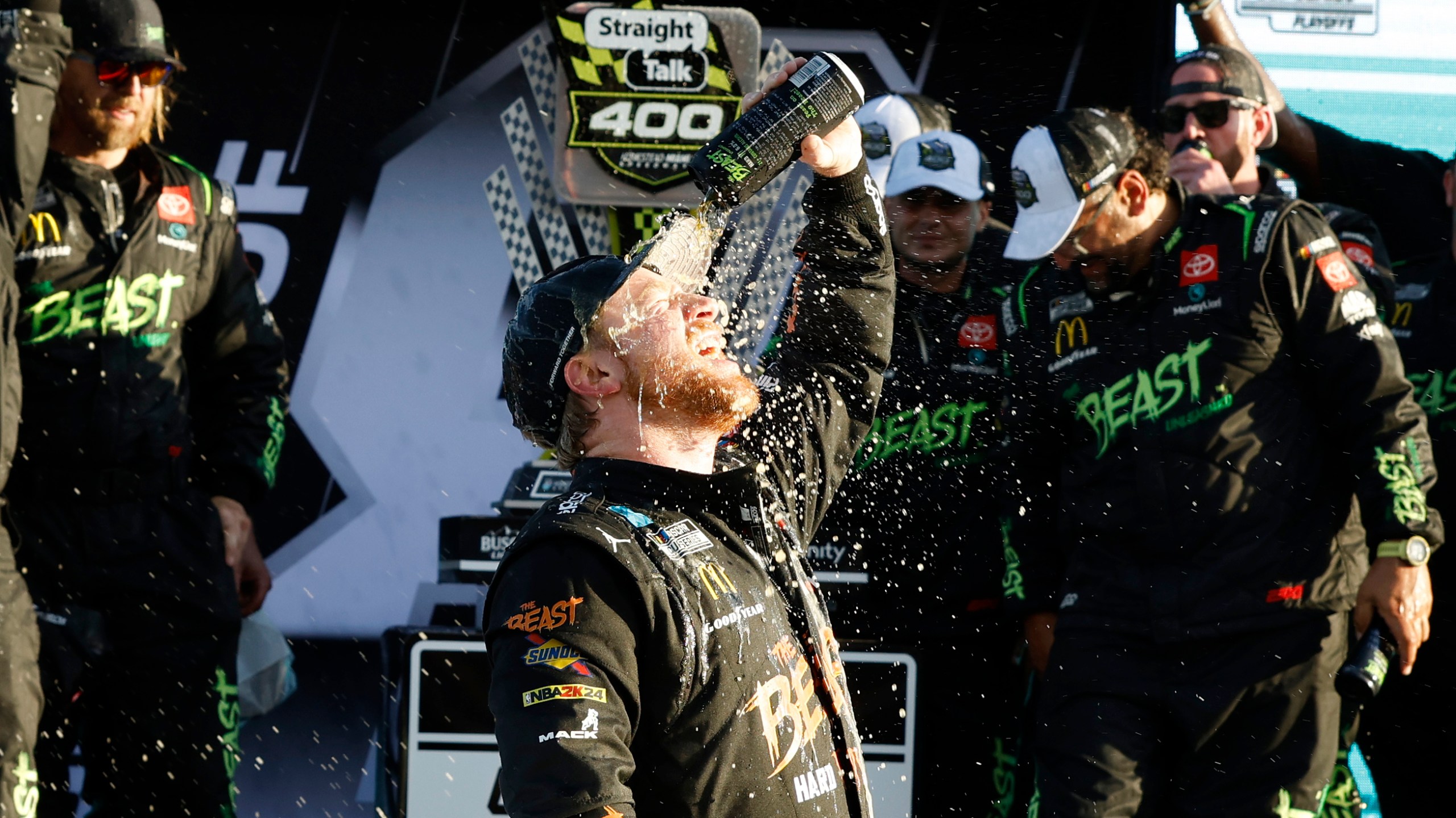 Tyler Reddick, center, celebrates in Victory Lane after winning a NASCAR Cup Series auto race at Homestead-Miami Speedway in Homestead, Fla., Sunday, Oct. 27, 2024. (AP Photo/Terry Renna)