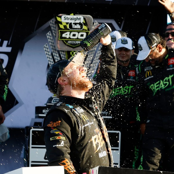 Tyler Reddick, center, celebrates in Victory Lane after winning a NASCAR Cup Series auto race at Homestead-Miami Speedway in Homestead, Fla., Sunday, Oct. 27, 2024. (AP Photo/Terry Renna)