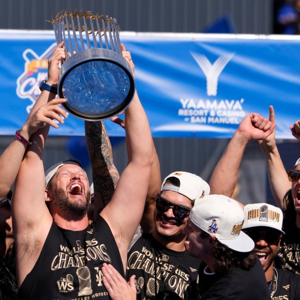 Los Angeles Dodgers pitcher Clayton Kershaw hold the World Series trophy during the baseball team's World Series championship parade and celebration at Dodger Stadium, Friday, Nov. 1, 2024, in Los Angeles. (AP Photo/Mark J. Terrill)