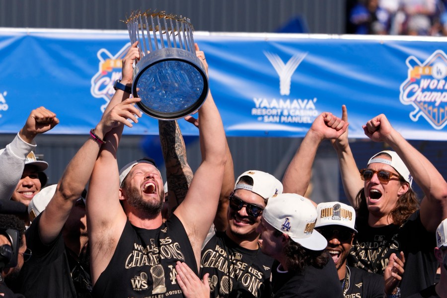 Los Angeles Dodgers pitcher Clayton Kershaw hold the World Series trophy during the baseball team's World Series championship parade and celebration at Dodger Stadium, Friday, Nov. 1, 2024, in Los Angeles. (AP Photo/Mark J. Terrill)