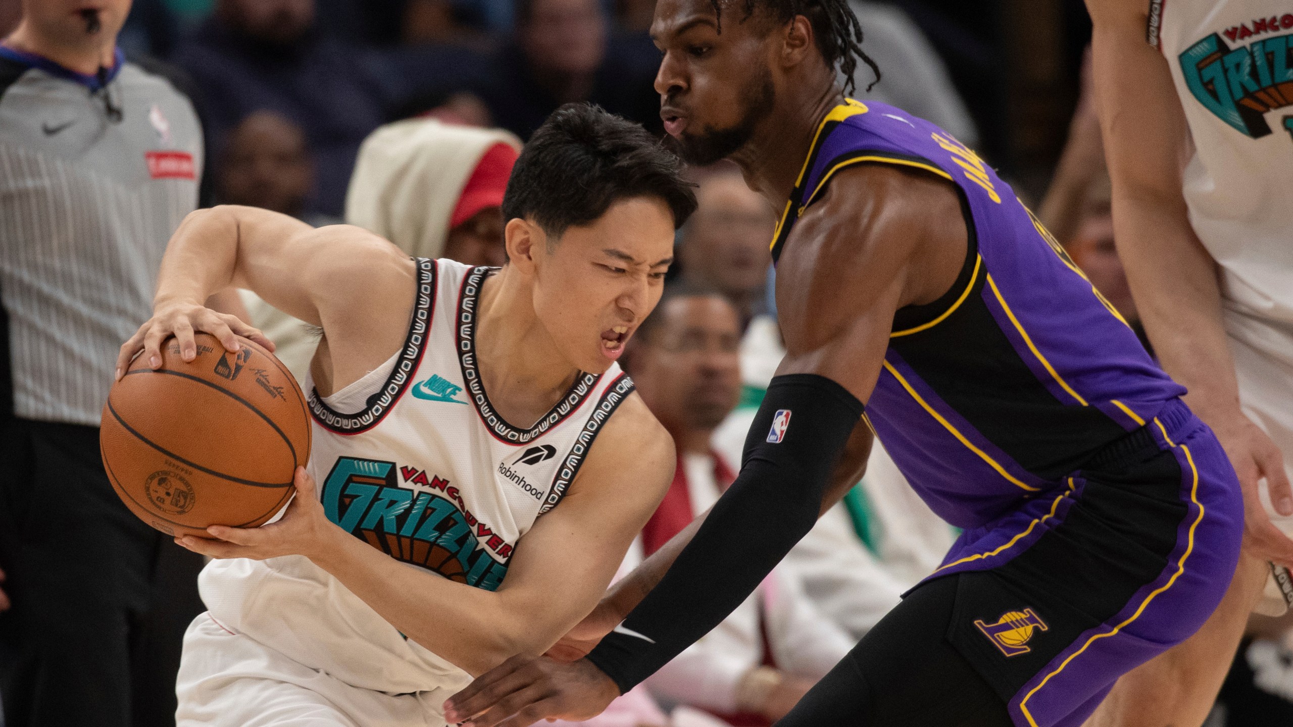 Los Angeles Lakers guard Bronny James (9) defends Memphis Grizzlies guard Yuki Kawamura (17), of Japan, in the second half of an NBA basketball game Wednesday, Nov. 6, 2024, in Memphis, Tenn. (AP Photo/Nikki Boertman)