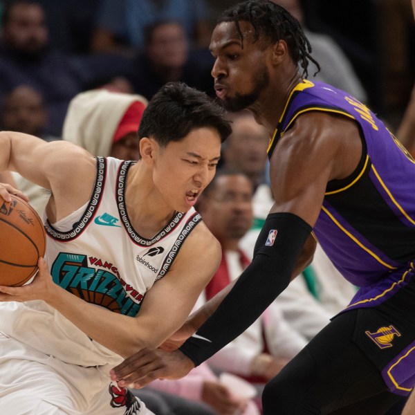 Los Angeles Lakers guard Bronny James (9) defends Memphis Grizzlies guard Yuki Kawamura (17), of Japan, in the second half of an NBA basketball game Wednesday, Nov. 6, 2024, in Memphis, Tenn. (AP Photo/Nikki Boertman)