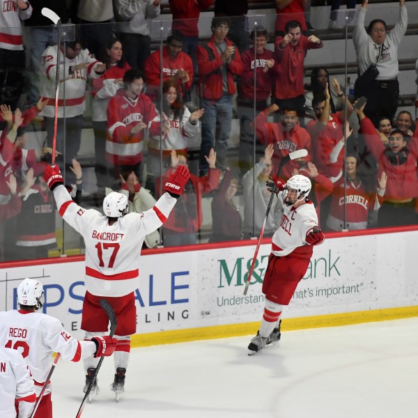 FILE - Cornell forward Kyle Penney, right, celebrates with forward Dalton Bancroft (17) after scoring during the third period of an NCAA hockey game against North Dakota on Nov. 2, 2024 in Ithaca, N.Y. (AP Photo/Adrian Kraus, file)