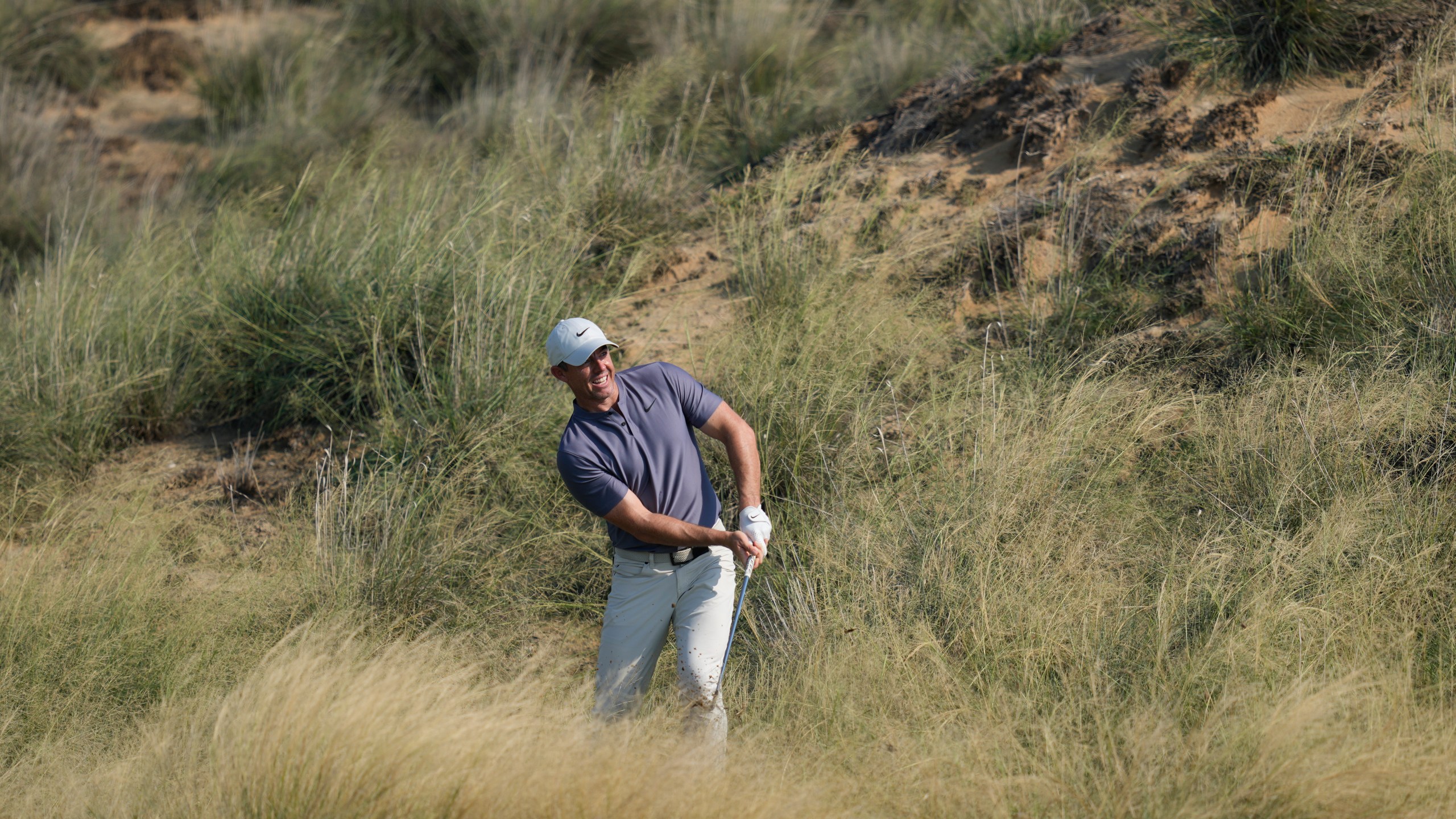 Rory McIlroy of Northern Ireland plays his second shot at the 13th hole during the second round of Abu Dhabi Golf Championship in Abu Dhabi, United Arab Emirates, Friday, Nov. 8, 2024. (AP Photo/Altaf Qadri)