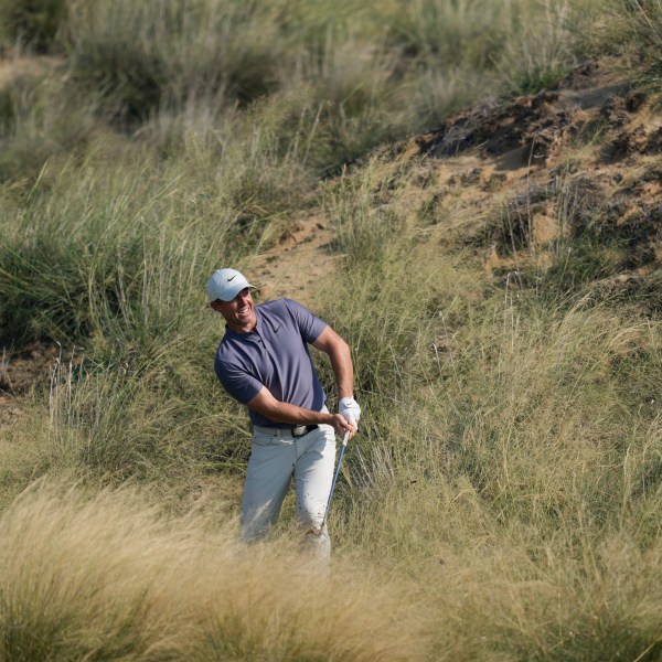 Rory McIlroy of Northern Ireland plays his second shot at the 13th hole during the second round of Abu Dhabi Golf Championship in Abu Dhabi, United Arab Emirates, Friday, Nov. 8, 2024. (AP Photo/Altaf Qadri)