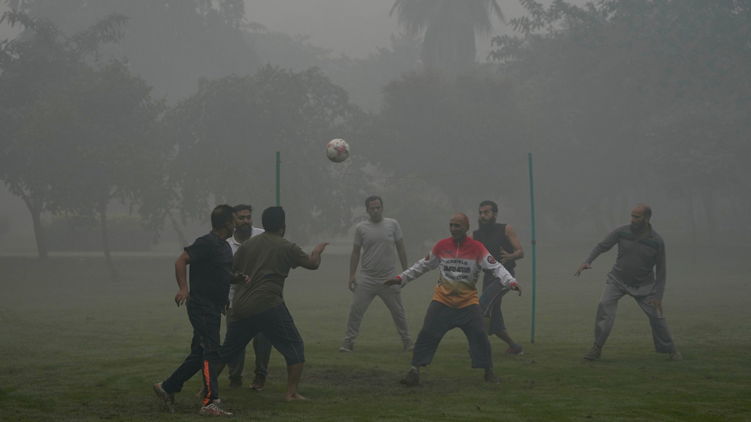 People play with soccer ball in a park in the morning as smog envelops the area of Lahore, Pakistan, Friday, Nov. 8, 2024. (AP Photo/K.M. Chaudary)