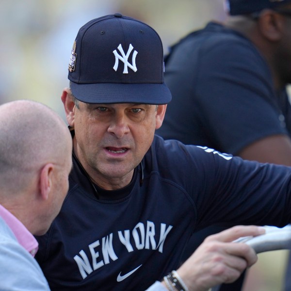 New York Yankees manager Aaron Boone, right, talks with general manager Brian Cashman during batting practice before Game 1 of the baseball World Series, Friday, Oct. 25, 2024, in Los Angeles. (AP Photo/Julio Cortez)