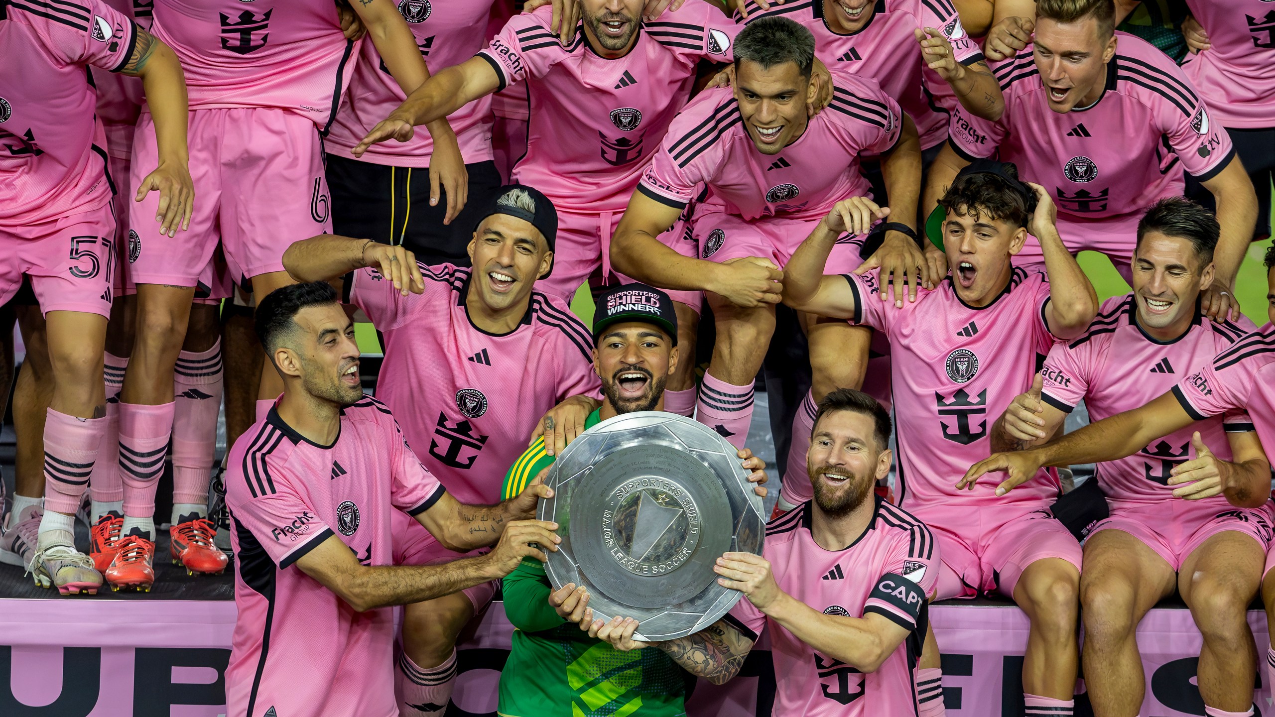 Inter Miami forward Lionel Messi, front, center right, celebrates with his teammates Sergio Busquets, front, center left, Luis Suárez, second row, left, and Drake Callender, center in green, after winning the Supporters' Shield, defeating the New England Revolution at Chase Stadium in Fort Lauderdale, Fla., Saturday, Oct. 19, 2024. (David Santiago/Miami Herald via AP)