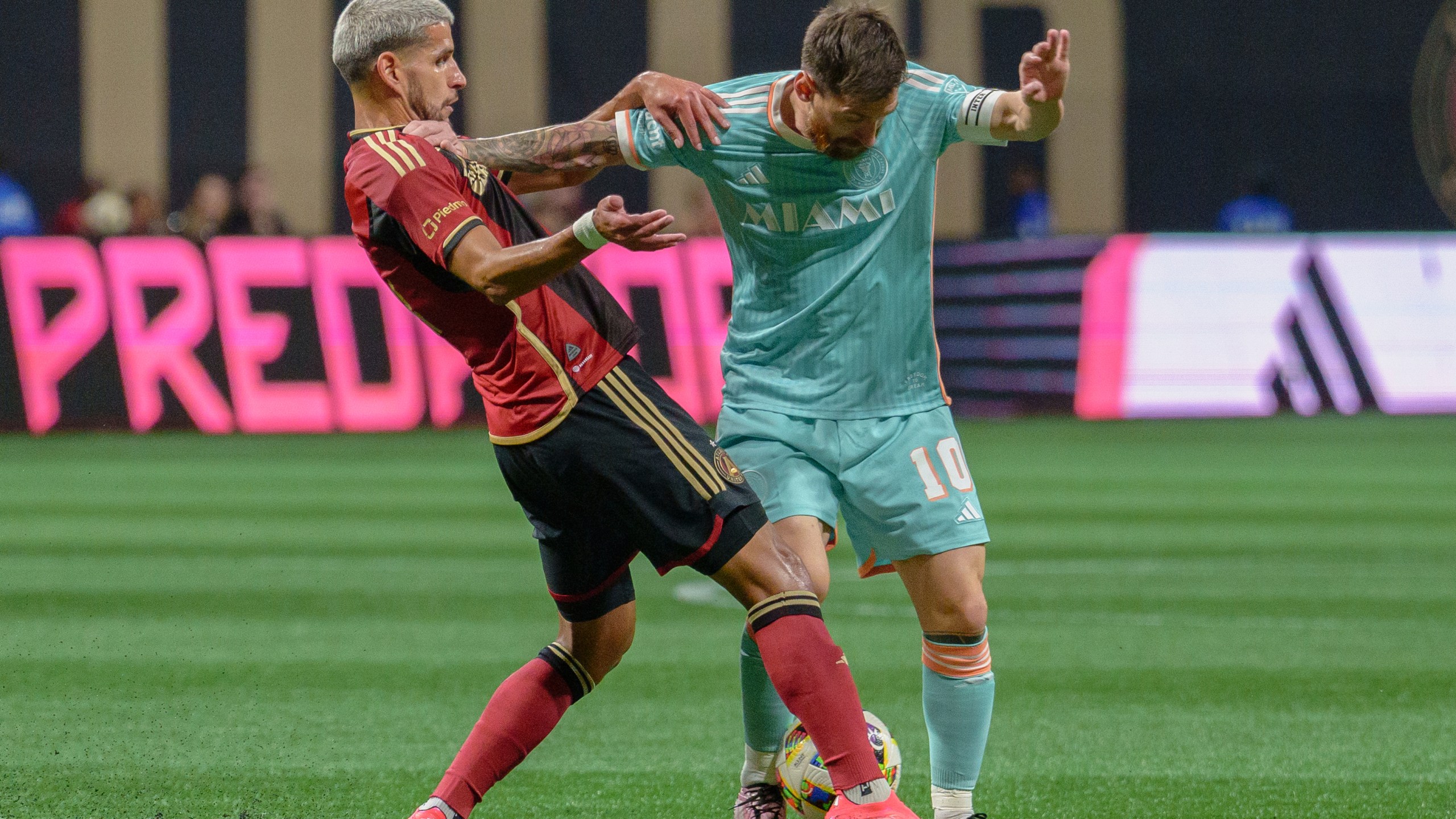 Inter Miami forward Lionel Messi (10) attempts to maintain the ball during the first half of an MLS soccer match against Atlanta United, Saturday, Nov. 2, 2024, in Atlanta. (AP Photo/Jason Allen)