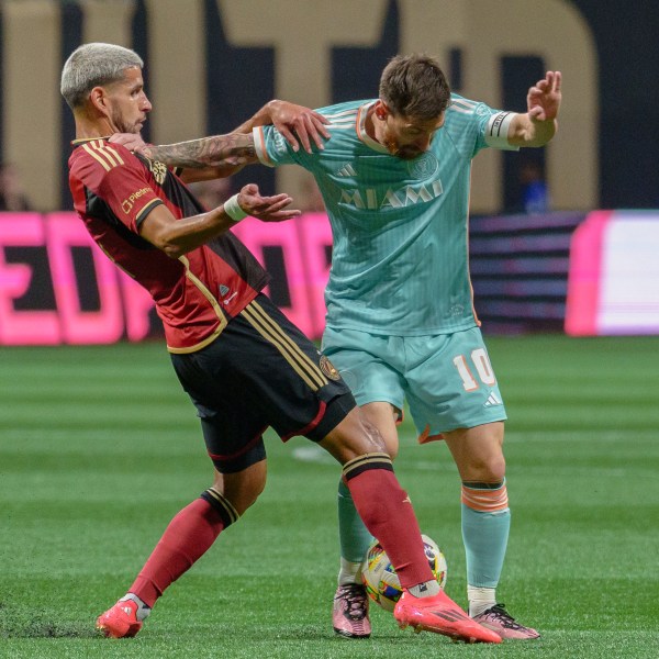 Inter Miami forward Lionel Messi (10) attempts to maintain the ball during the first half of an MLS soccer match against Atlanta United, Saturday, Nov. 2, 2024, in Atlanta. (AP Photo/Jason Allen)