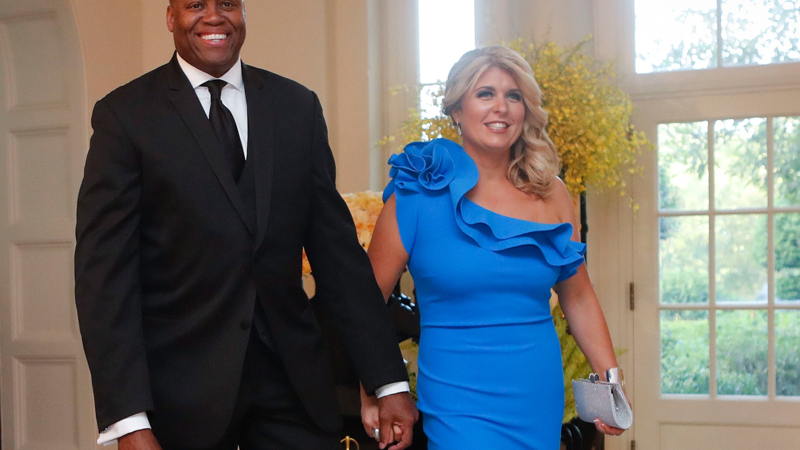 FILE - Craig Robinson, brother of former first lady Michelle Obama, and his wife, Kelly Robinson, arrive for a State Dinner for Singapore's Prime Minister Lee Hsien Loong, Aug. 2, 2016, at the White House in Washington. (AP Photo/Pablo Martinez Monsivais, File)