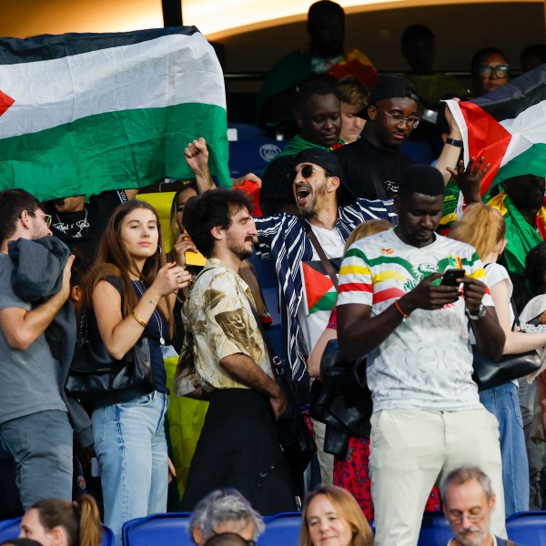 FILE - Spectators hold Palestinian flags as they watch the men's group D match between Israel and Mali at the Parc des Princes during the 2024 Summer Olympics, Wednesday, July 24, 2024, in Paris, France. (AP Photo/Aurelien Morissard, File)