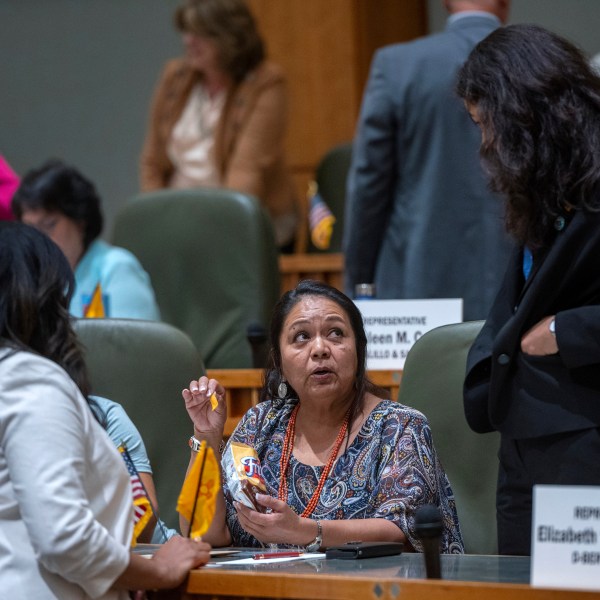 House Maj. Whip Reena Szczepanski, D-Santa Fe, left, Rep. D. Wonda Johnson, D-Church Rock, center, and Rep. Cristina Parajon, D-Albuquerque, talk before the start of a special session, in Santa Fe, N.M., Thursday, July 18, 2024. (Eddie Moore/The Albuquerque Journal via AP)