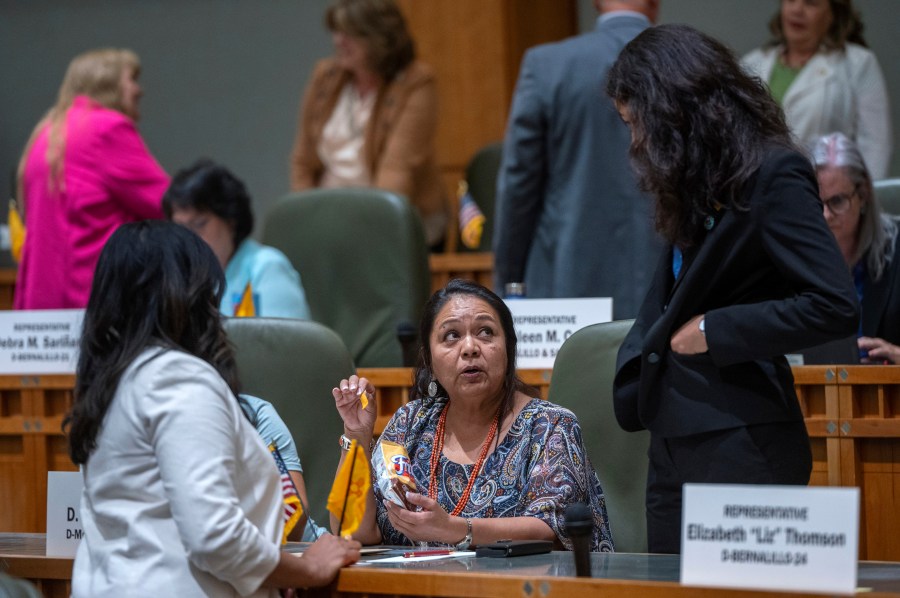 House Maj. Whip Reena Szczepanski, D-Santa Fe, left, Rep. D. Wonda Johnson, D-Church Rock, center, and Rep. Cristina Parajon, D-Albuquerque, talk before the start of a special session, in Santa Fe, N.M., Thursday, July 18, 2024. (Eddie Moore/The Albuquerque Journal via AP)