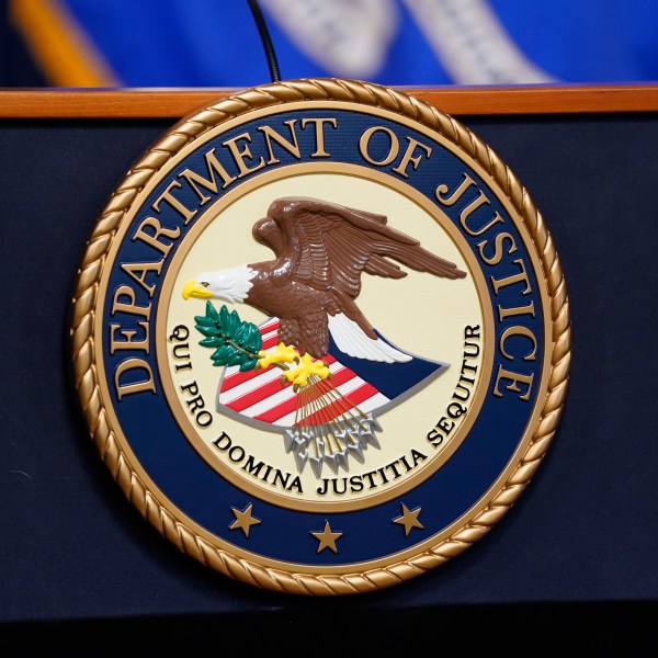 FILE - The seal for the United States Department of Justice is displayed on a podium before a news conference at the Justice Department in Washington, Thursday, April 13, 2023. (AP Photo/Evan Vucci, File)