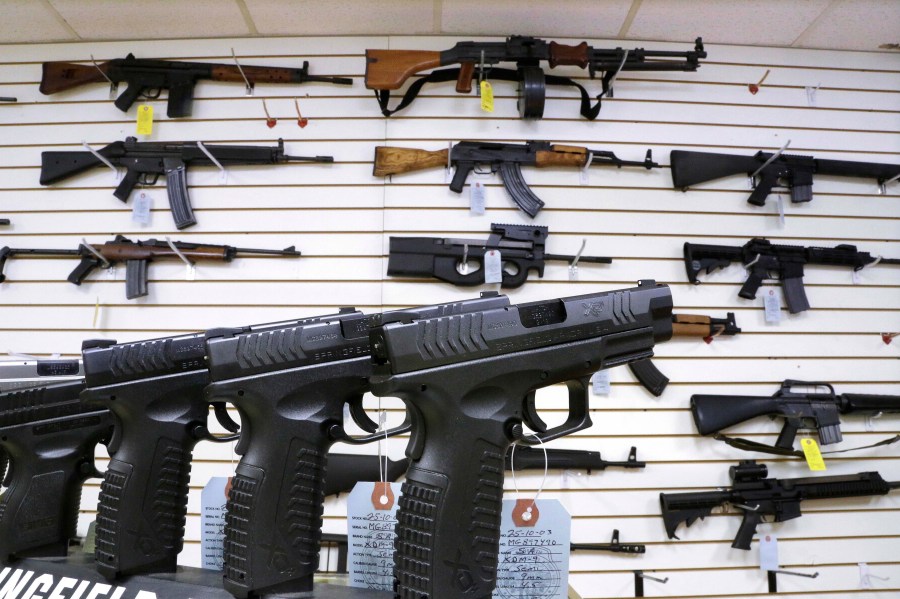 FILE - Assault style weapons and hand guns are displayed for sale at Capitol City Arms Supply on Jan. 16, 2013, in Springfield, Ill. (AP Photo/Seth Perlman, File)