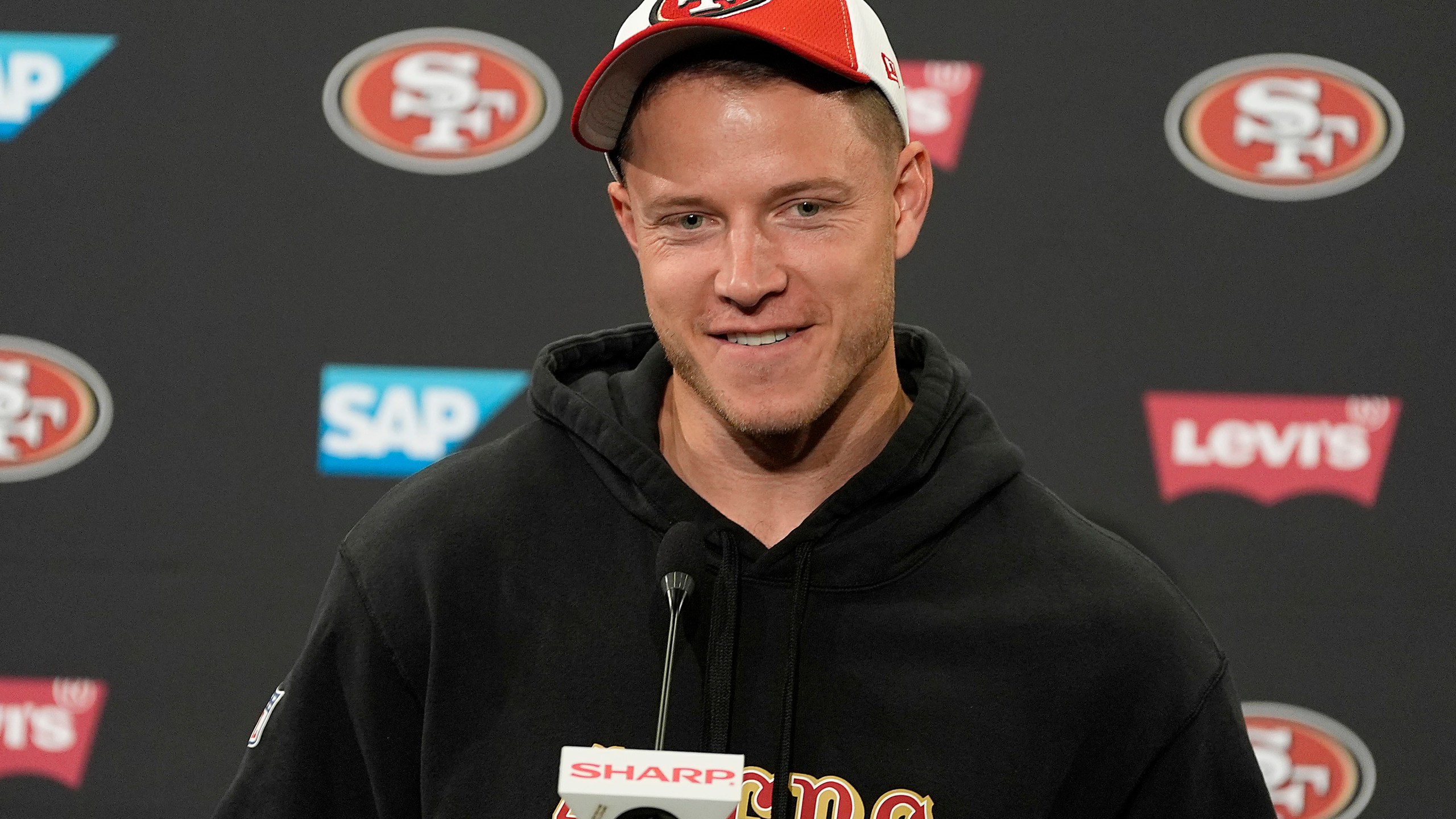 FILE - San Francisco 49ers running back Christian McCaffrey speaks with the media after NFL football practice in Santa Clara, Calif., Tuesday, June 4, 2024. (AP Photo/Tony Avelar, File)