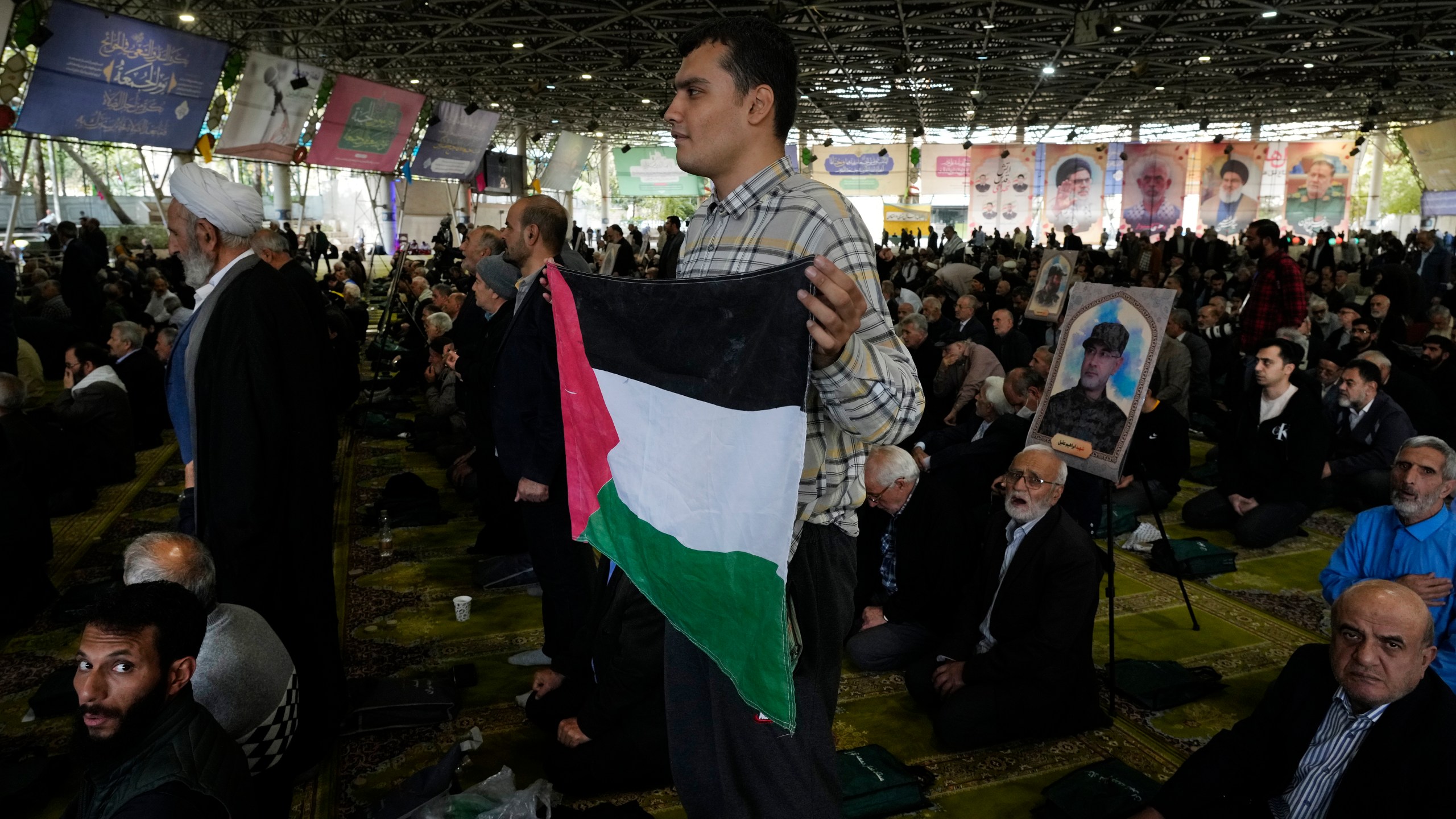 An Iranian worshipper holds a Palestinian flag during Friday prayer ceremony at the Tehran University campus, in Tehran, Iran, Friday, Nov. 8, 2024. (AP Photo/Vahid Salemi)