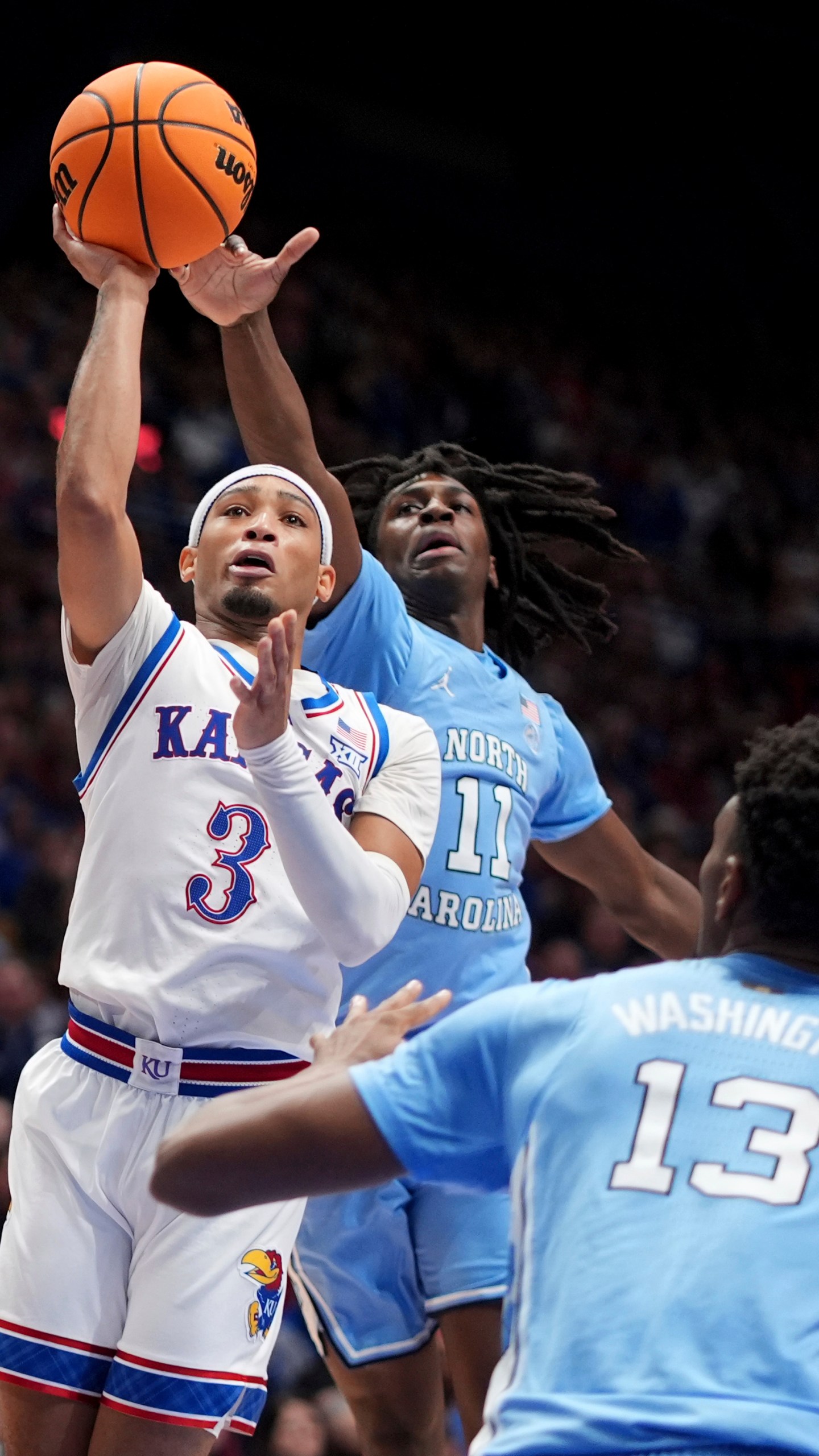 Kansas guard Dajuan Harris Jr. (3) shoots under pressure from North Carolina guard Ian Jackson (11) during the first half of an NCAA college basketball game Friday, Nov. 8, 2024, in Lawrence, Kan. (AP Photo/Charlie Riedel)