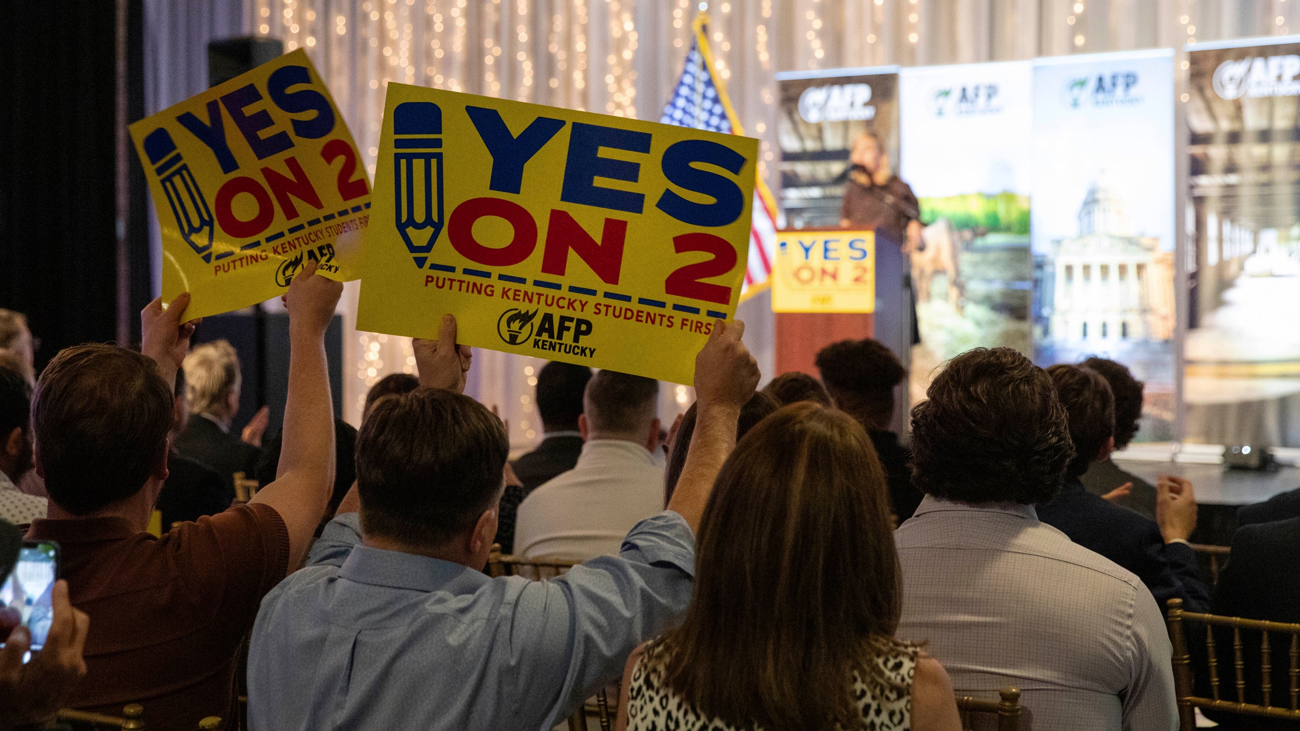 Supporters of Kentucky's Amendment 2 wave signs and foam fingers as Kelley Paul speaks at the Americans for Prosperity—Kentucky rally for Amendment 2 alongside her husband, U.S. Sen. Rand Paul, and former Kentucky Attorney Gen. Daniel Cameron at La Gala in downtown Bowling Green, Ky., Monday, Oct. 28, 2024. (Grace Ramey McDowell/Daily News via AP)