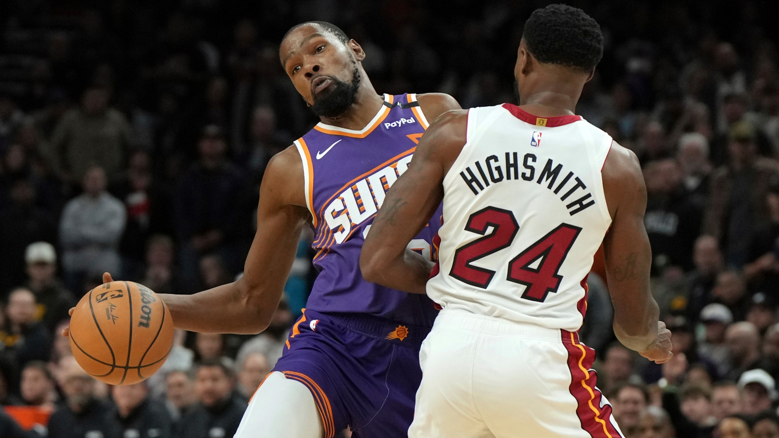 Miami Heat forward Haywood Highsmith (24) fould Phoenix Suns forward Kevin Durant during the second half of an NBA basketball game, Wednesday, Nov. 6, 2024, in Phoenix. Phoenix won 115-112. (AP Photo/Rick Scuteri)