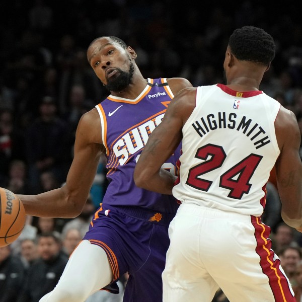 Miami Heat forward Haywood Highsmith (24) fould Phoenix Suns forward Kevin Durant during the second half of an NBA basketball game, Wednesday, Nov. 6, 2024, in Phoenix. Phoenix won 115-112. (AP Photo/Rick Scuteri)