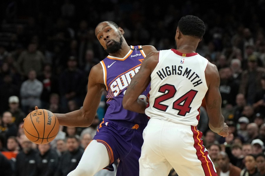 Miami Heat forward Haywood Highsmith (24) fould Phoenix Suns forward Kevin Durant during the second half of an NBA basketball game, Wednesday, Nov. 6, 2024, in Phoenix. Phoenix won 115-112. (AP Photo/Rick Scuteri)