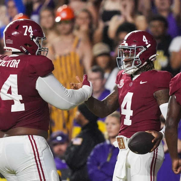 Alabama quarterback Jalen Milroe (4) celebrates his touchdown carry with Alabama offensive lineman Kadyn Proctor (74) in the first half an NCAA college football game against LSU in Baton Rouge, La., Saturday, Nov. 9, 2024. (AP Photo/Gerald Herbert)