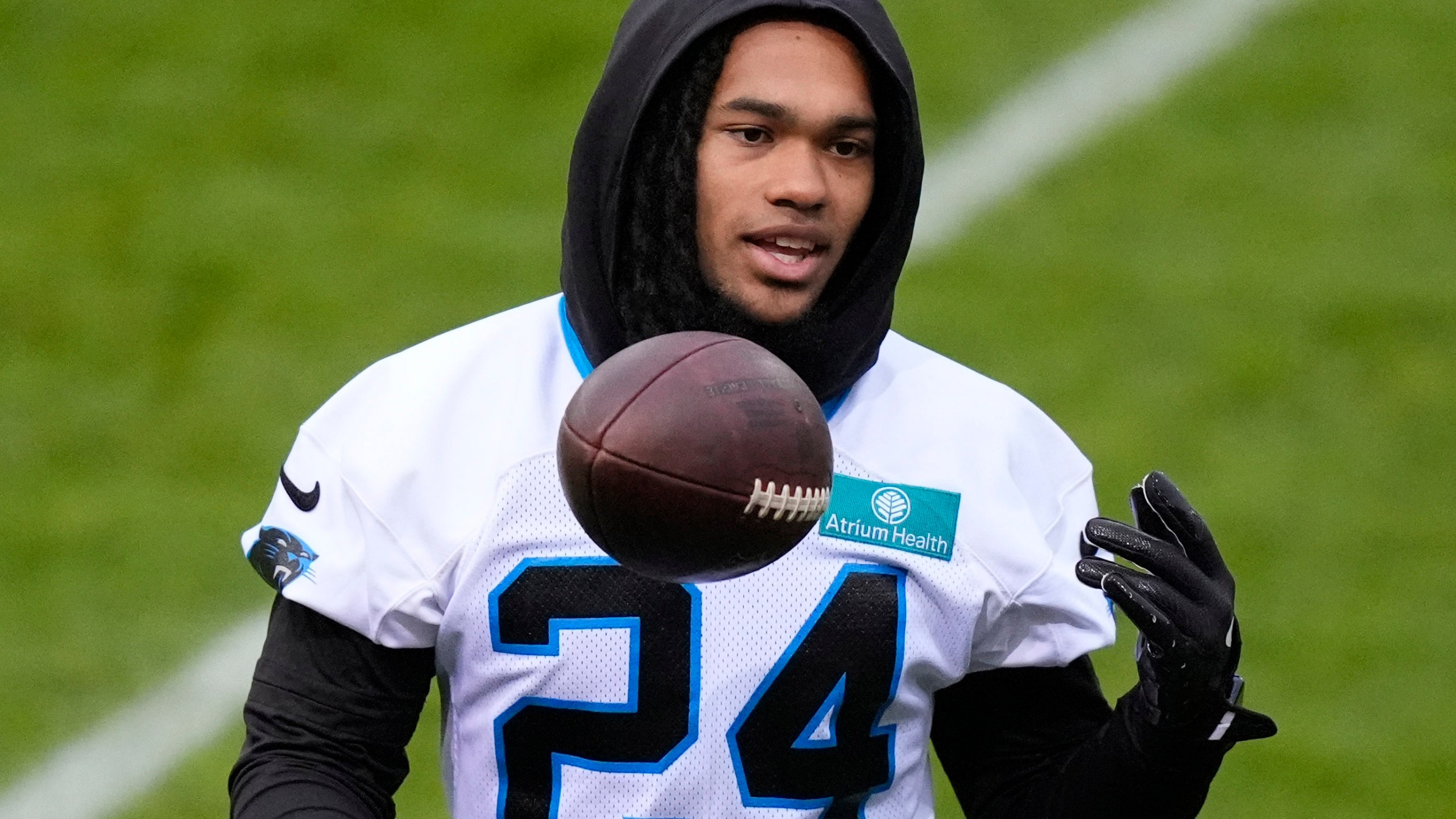 Carolina Panthers running back Jonathon Brooks (24) lifts a ball during a practice session in Munich, Germany, Friday, Nov. 8, 2024. The Carolina Panthers are set to play the New York Giants in an NFL game at the Allianz Arena in Munich on Sunday Nov. 10. (AP Photo/Matthias Schrader)