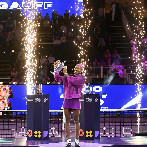 Coco Gauff of the U.S. holds her trophy next to China's Qinwen Zheng, after defeating her in their women's singles final match of the WTA finals at the King Saud University Indoor Arena, in Riyadh, Saudi Arabia, Saturday, Nov. 9, 2024. (AP Photo)