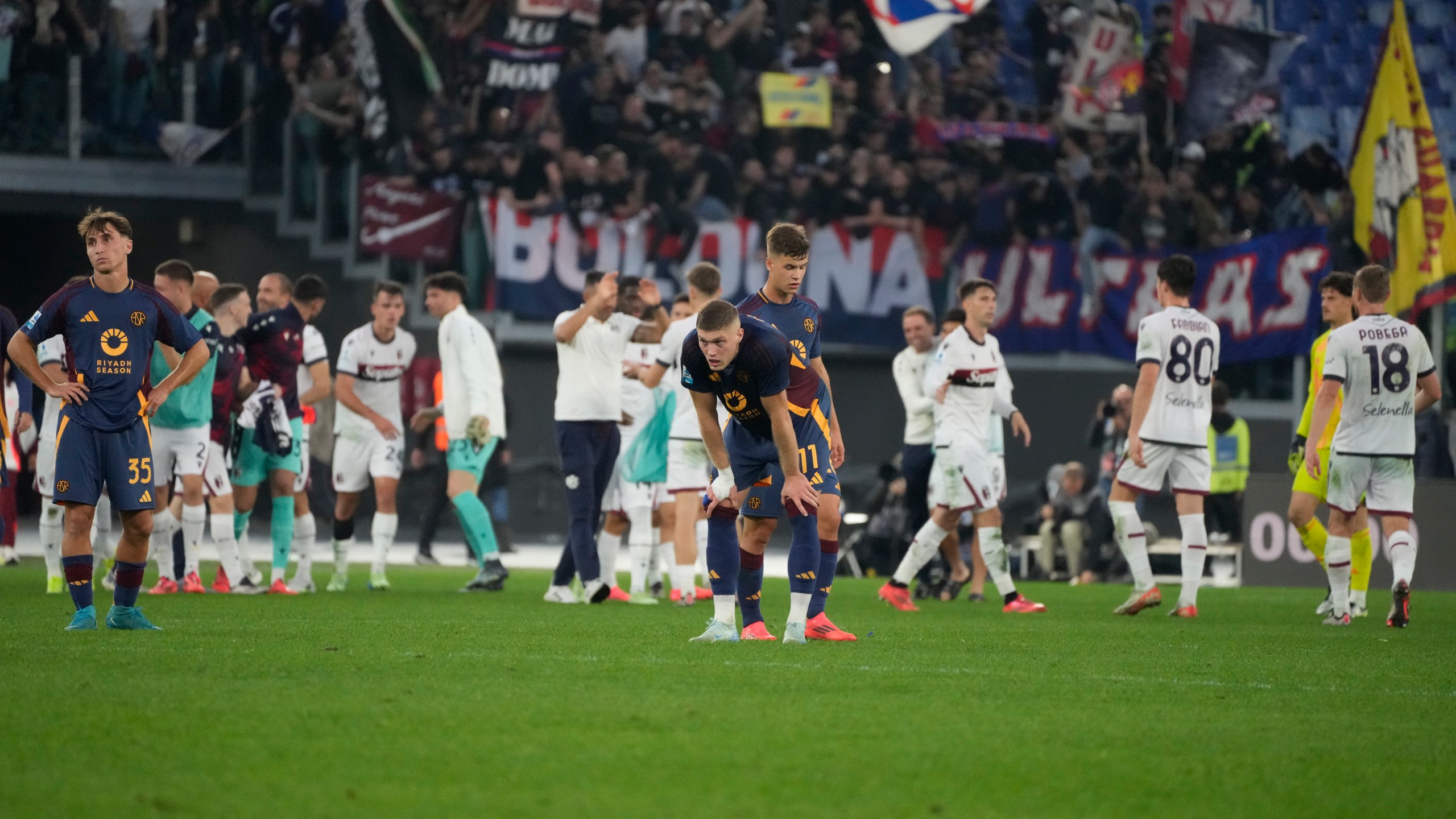 Roma players stand dejected after the Serie A soccer match between Roma and Bologna at Rome's Olympic Stadium, Sunday, Nov. 10, 2024. (AP Photo/Gregorio Borgia)