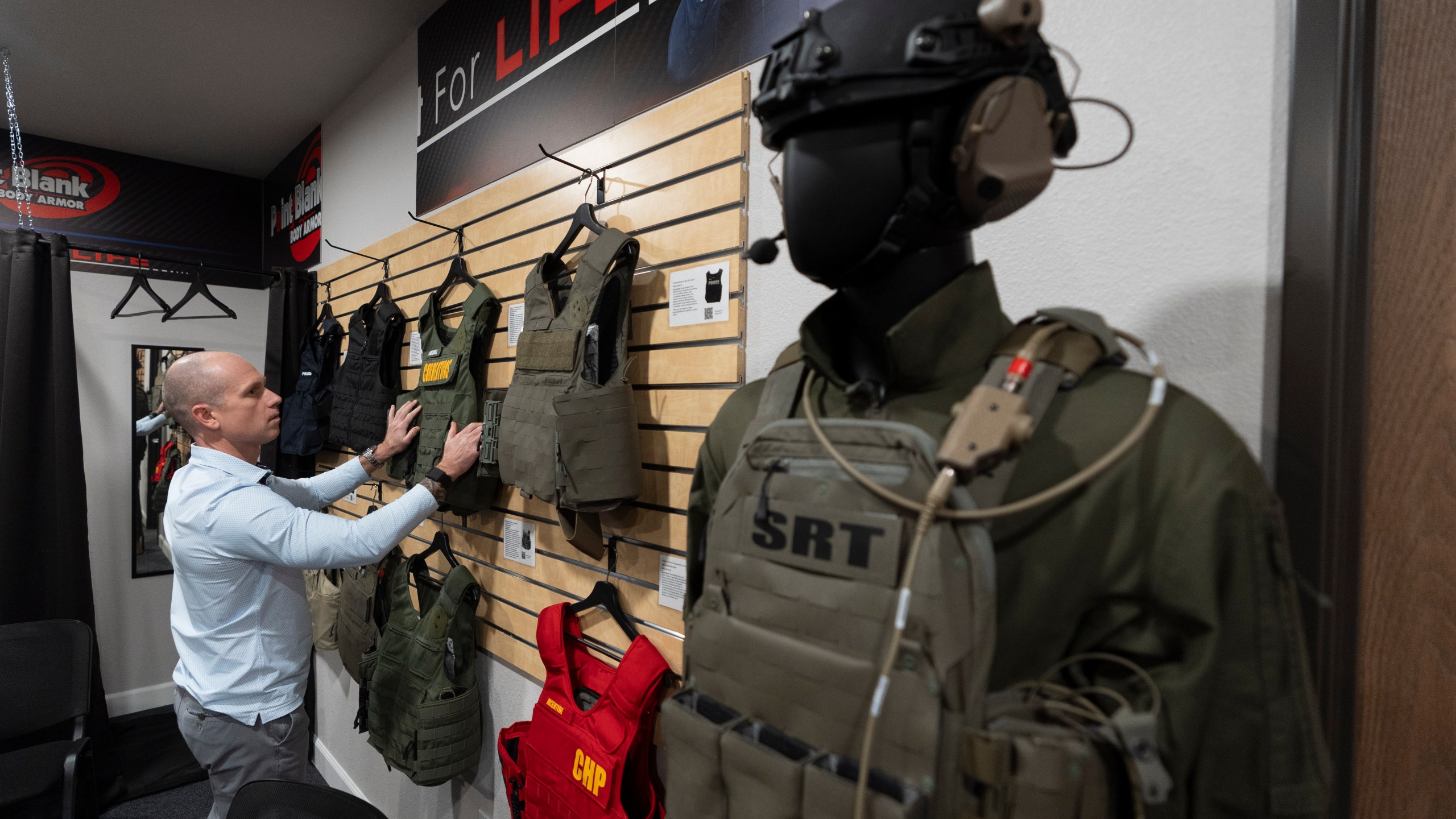 Veteran and business owner Jackson Dalton arranges protective gear at the Black Box Safety offices, Thursday, Nov. 7, 2024, in El Cajon, Calif. (AP Photo/Gregory Bull)